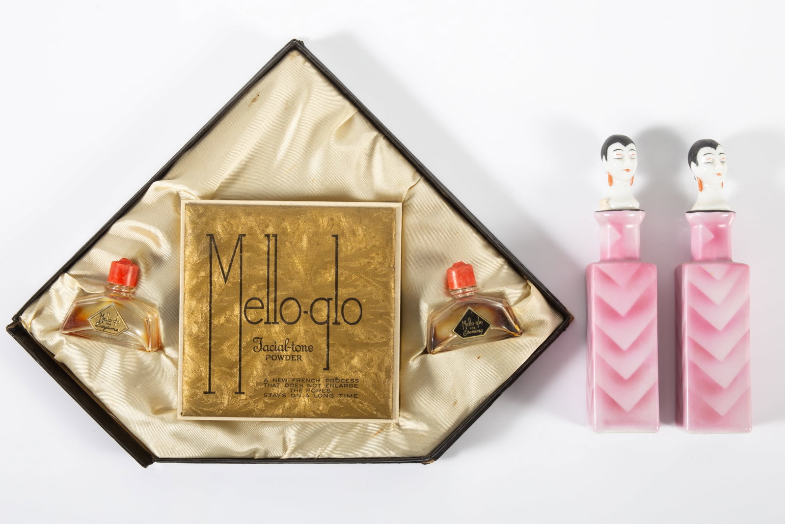 (3) DECO PERFUMES: (2) painted porcelain bottles with head stopers, H-5 1/2"; (1) boxed set "Mello-Glow" perfume and powder, H-8"; normal wear, G-VG