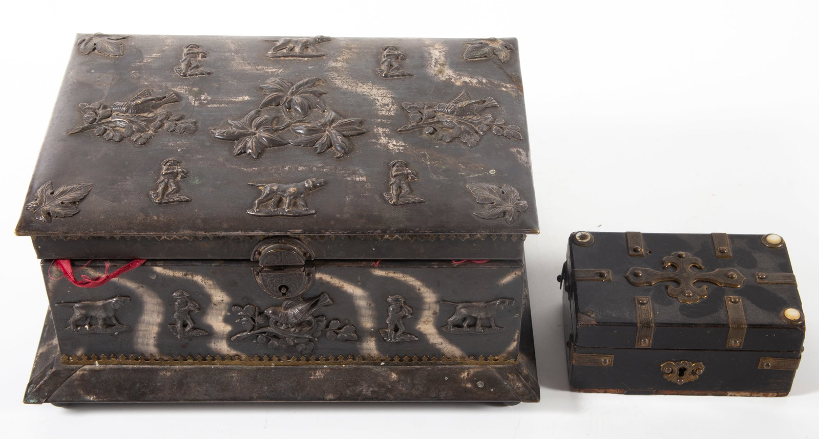 (2) VINTAGE DRESSER BOXES: (1) larger (10") patinated metal with applied metal figures and flowers, interior is fitted with tray; (1) small box - lacquered wood with trim, (2) buttons missing,