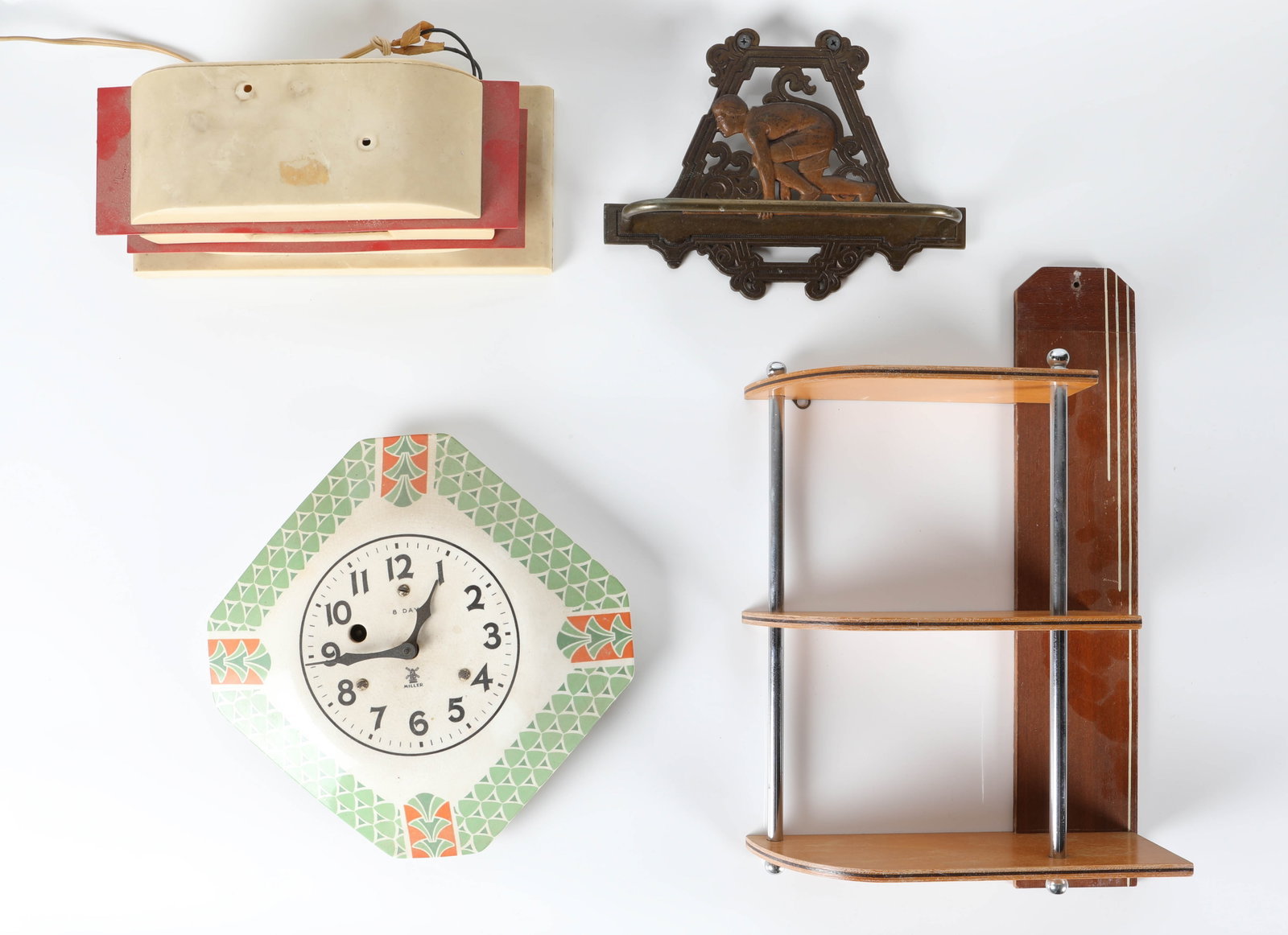 (4) DECO DECORATIVE OBJECTS: (1) Tele-vision clock, plastic and metal, missing handle, runs; (1) Miller "Triangle" clock, key wound, not running; (1) iron figural towel bar, track figure; (1) deco wall shelf, wood and chrome; H