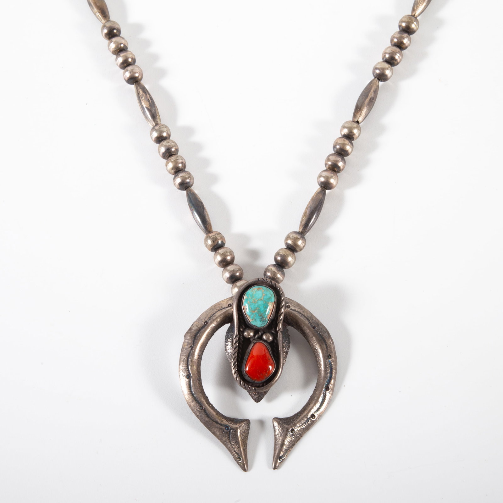 SOUTHWEST NECKLACE: Silver beaded necklace with silver drop containing bezeled natural turquoise and coral stones; 27"; 2.99 T.O., VG-EX