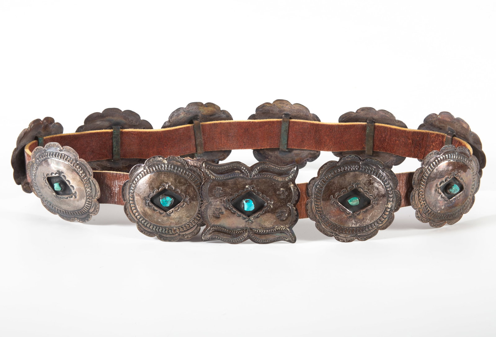 SOUTHWEST CONCHO BELT: Leather belt with (10) flower form silver slides with turquoise center and silver rectangular buckle with turquoise center; 16.08 T.O.; L-42", G-VG