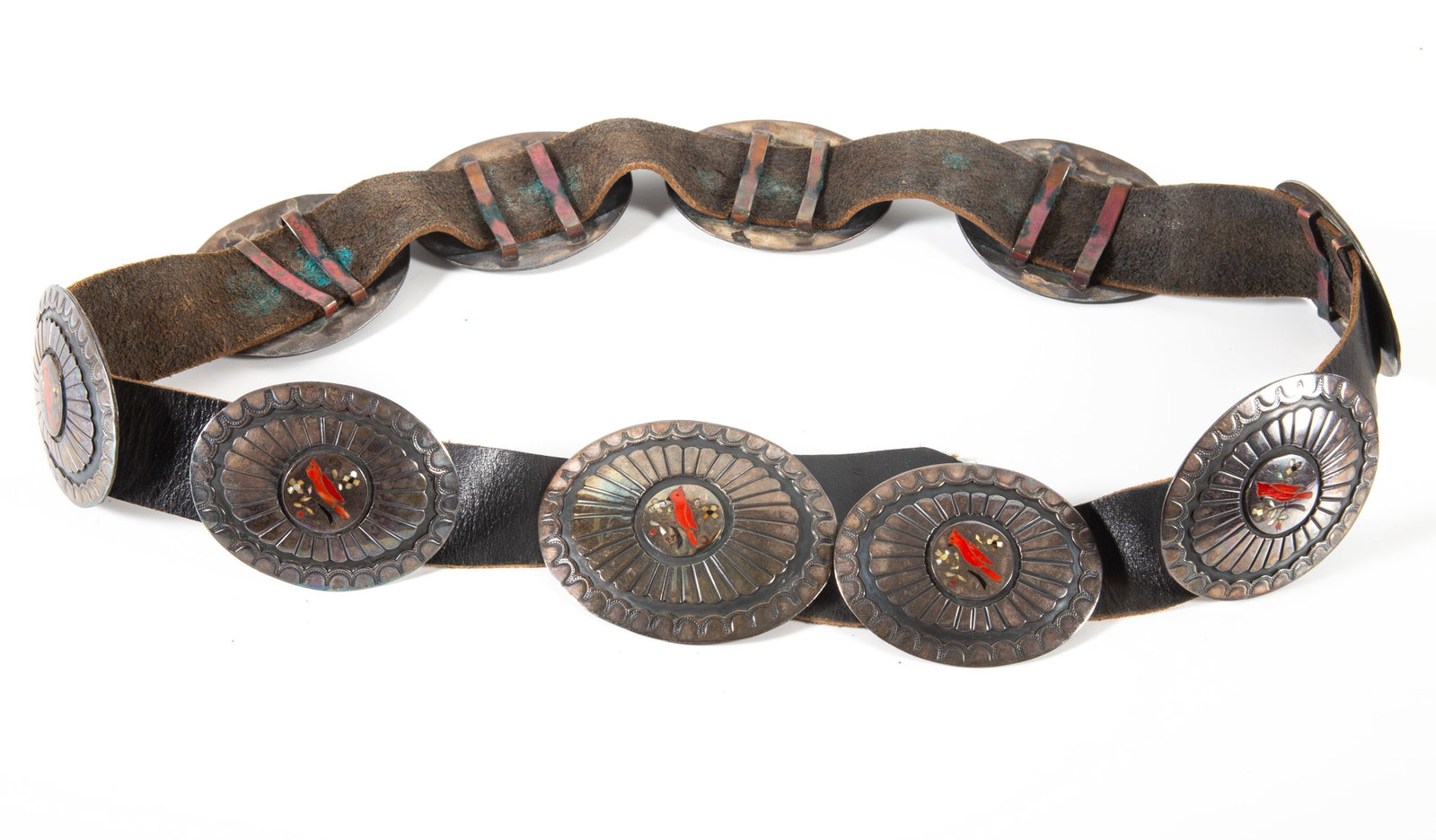 SOUTHWEST CONCHO BELT: Leather belt with (9) silver oval slides and buckle with inlaid coral bird and mother of pearl accent; 43"; 17.27 T.O., VG-EX
