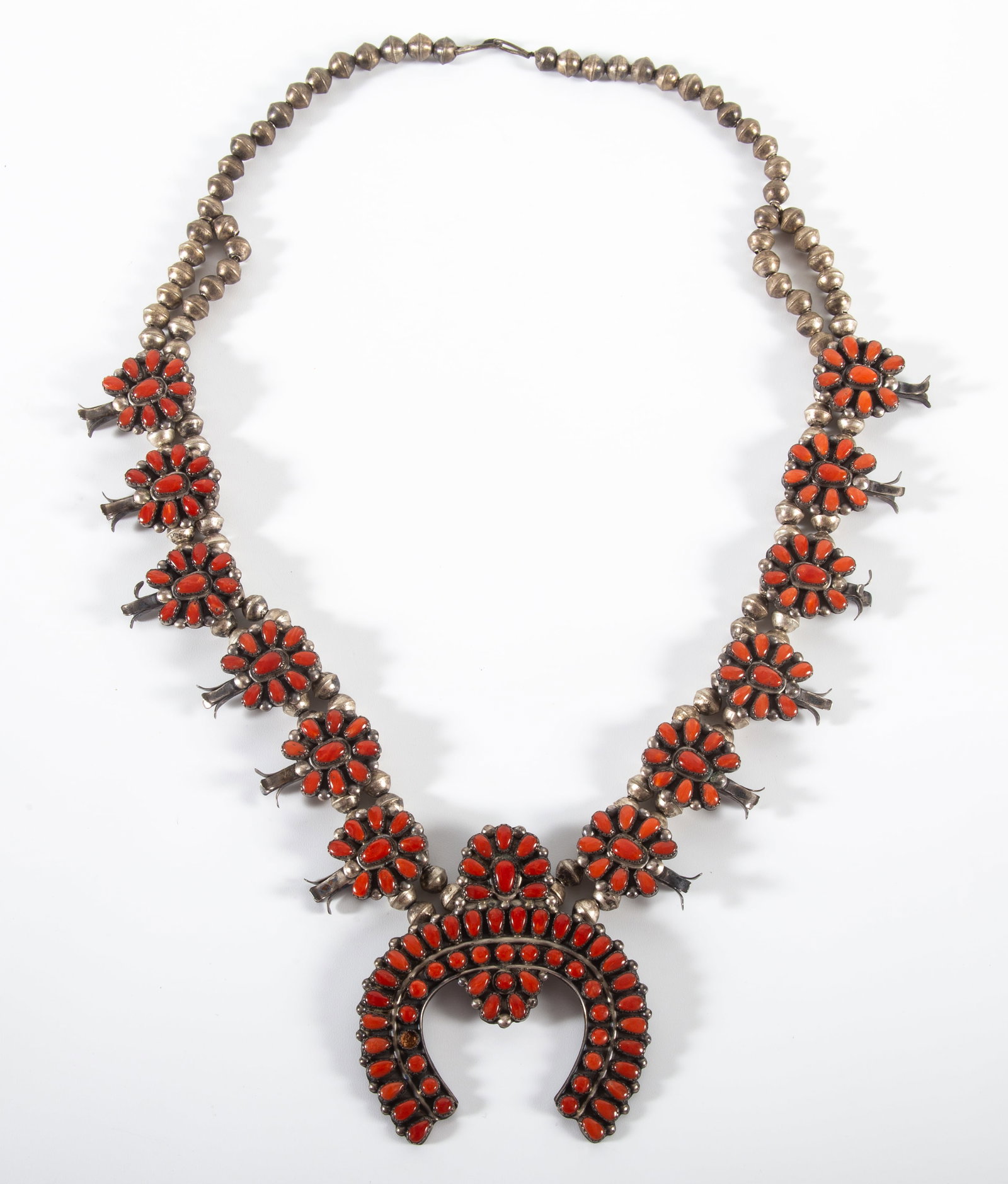 SOUTHWEST SQUASH BLOSSOM NECKLACE: Silver and coral; 26 1/2"; 4.55 T.O.; (1) inset coral on drop is missing, G-VG