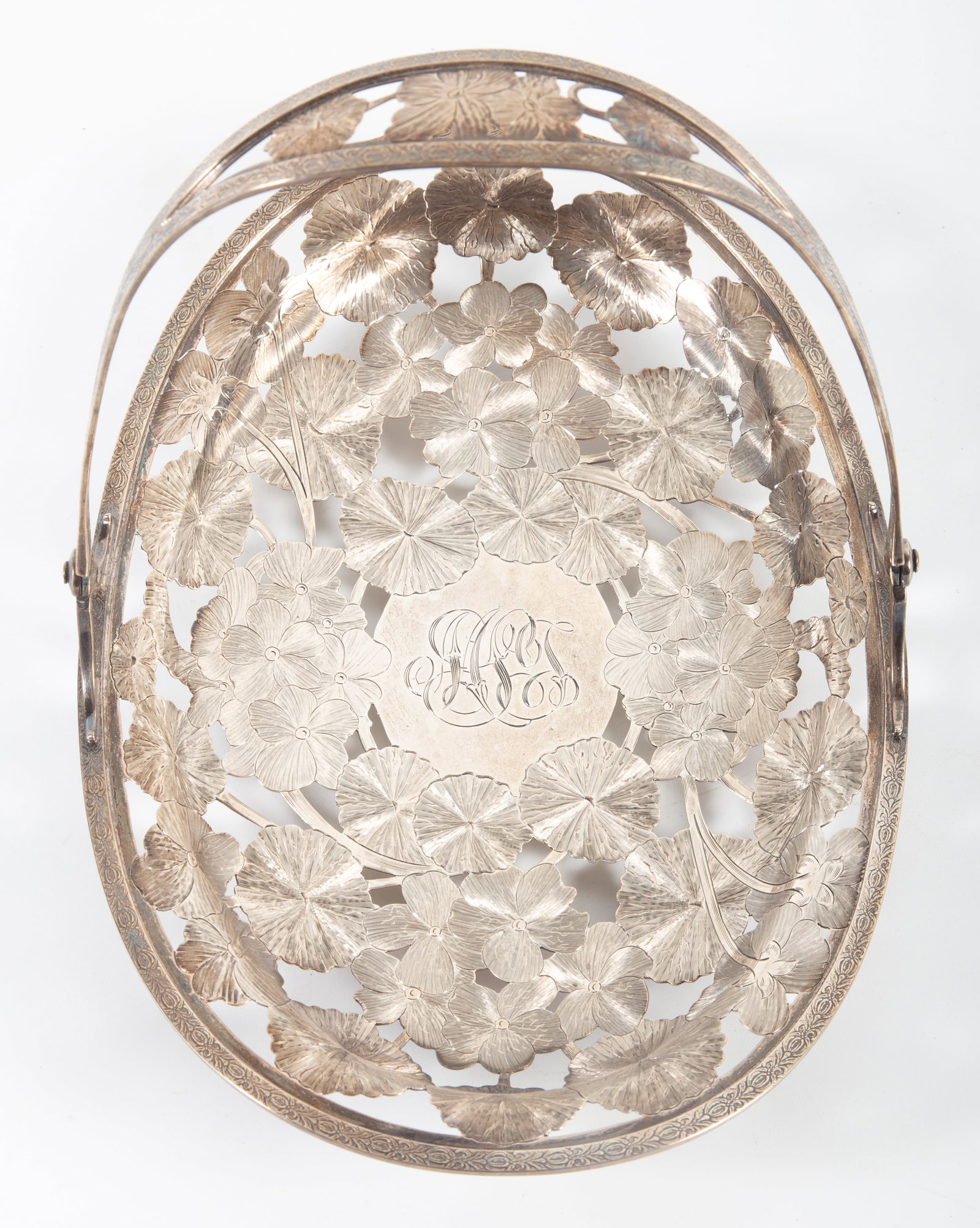 WHITING STERLING BASKET: Openwork floral engraved basket with swing handle; ball feet; monogrammed M.S.J.(?); #7495; 13.3 T.O.; H-7"xW-10"; normal wear, VG
