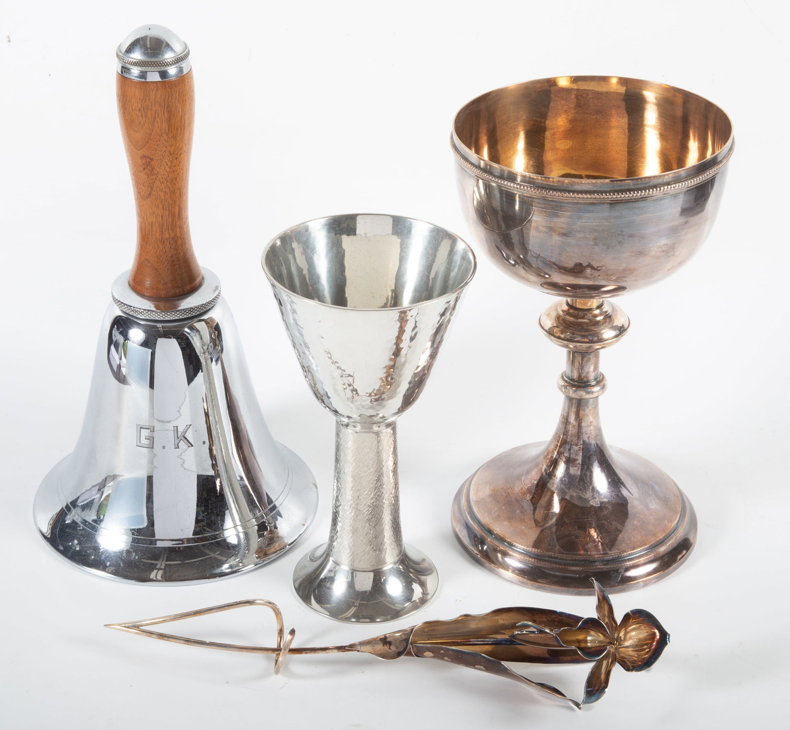 (4) PIECES PLATEDWARE: (1) tall chalice, silver plate; (1) bell form shaker, silver plate; (1) decorative flower, silver plate; (1) small chalice, polished pewter; H 7 1/2"-11"; normal wear, VG