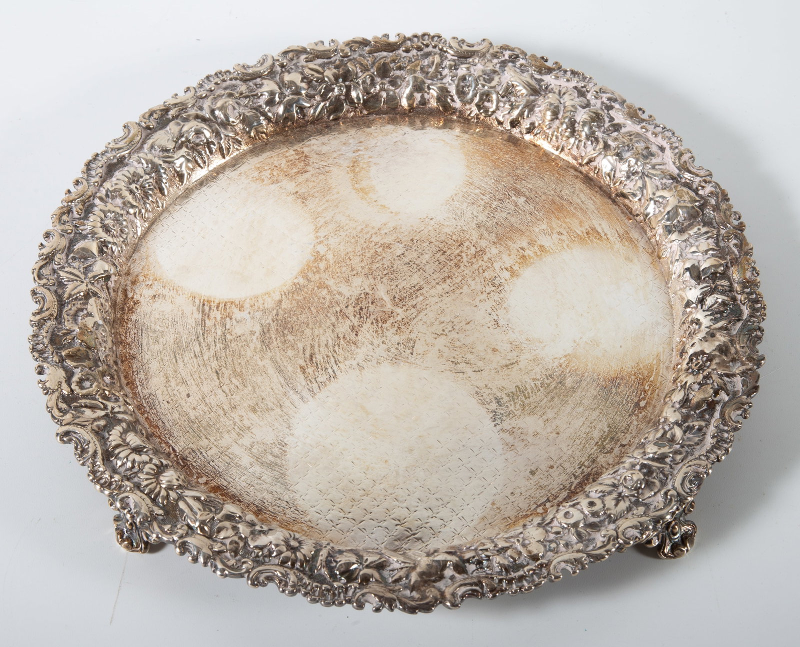 STERLING TAZZA: S. Kirk & Son, repousse decorated border, engraved surface, (4) feet, H-1"xD-9 1/2", 11.2 T.O., polish wear, F-G