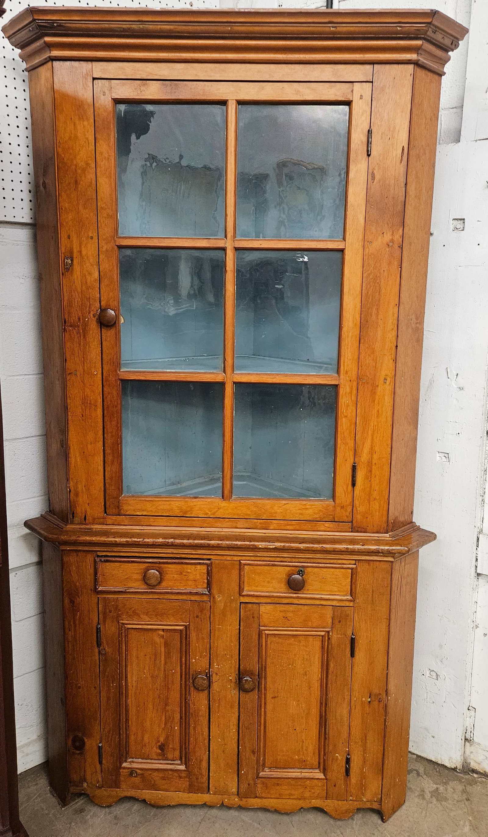 COUNTRY CORNER CUPBOARD: Pine and softwood; single door top over (2) drawers and (2) doors; H-91"xW-44"; old refinish; normal wear, G-G+