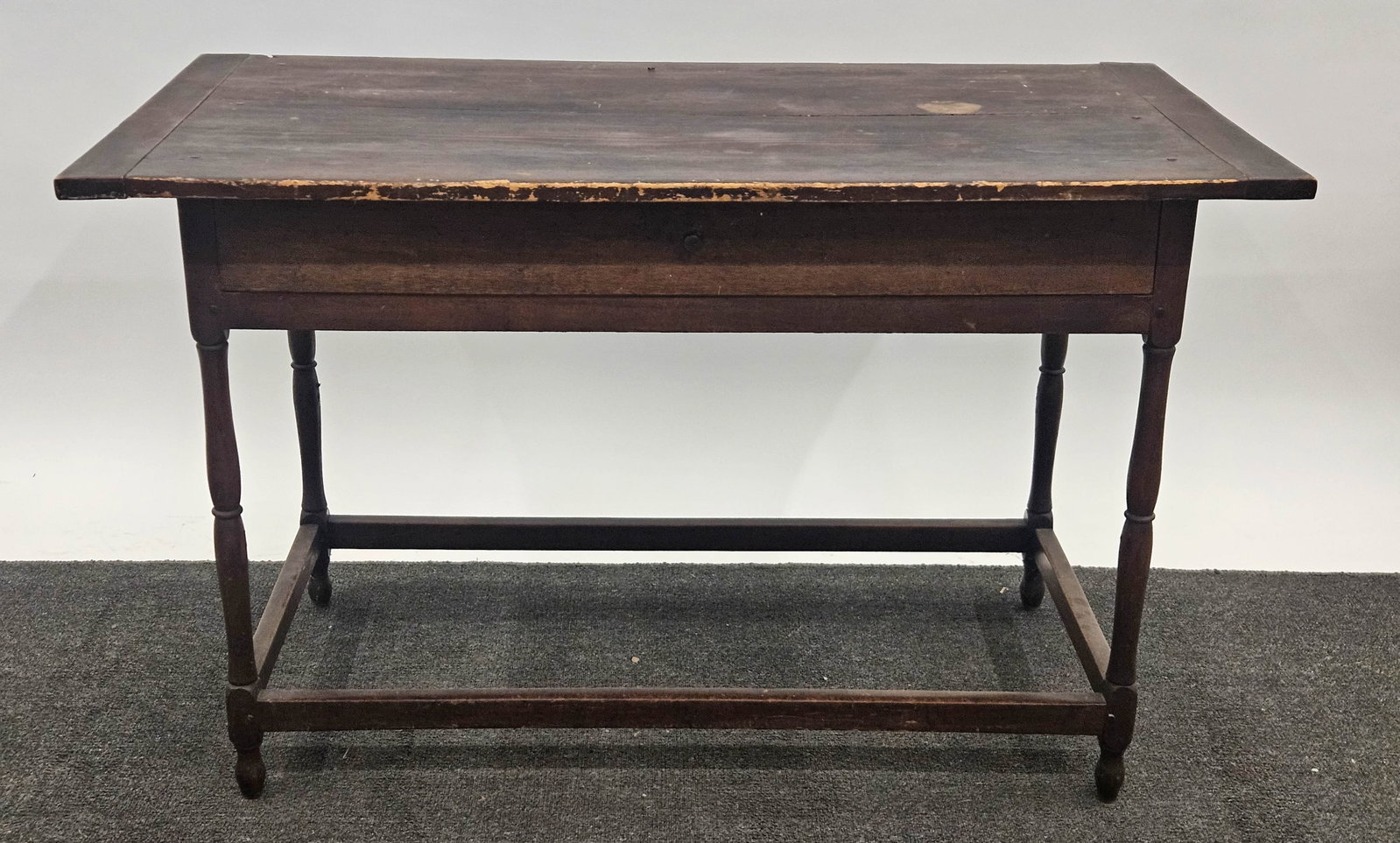 SINGLE DRAWER TAVERN TABLE: Stained pine; turned legs; H-29"xW-47"; normal wear, G