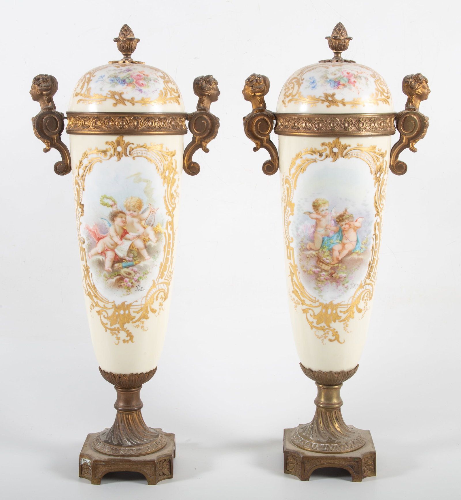 PAIR OF SERVES(?) URNS: Hand painted with cherubs and musical instruments (all different) vinettes; both have lids and bronze ormolu finials, rims, and bases; vinettes are signed (Solet?); H-17"{; normal wear, G-VG