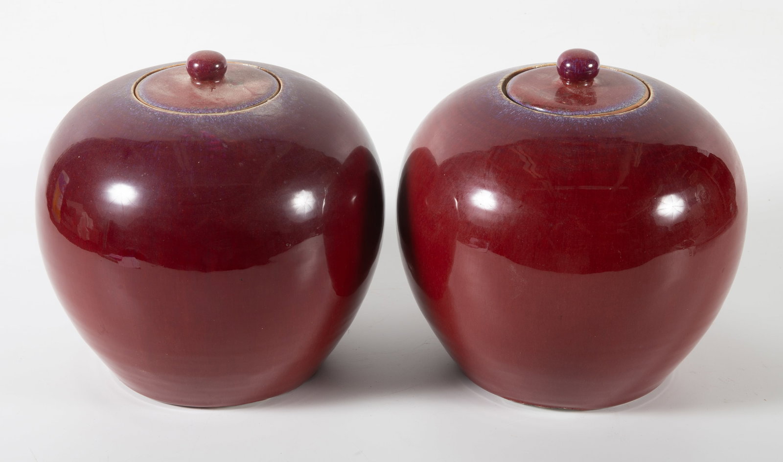 PAIR SANG DE BOEUF JARS: With lids; H-8"; base has firing glaze, losses, (1) lid has small chip, G-G+