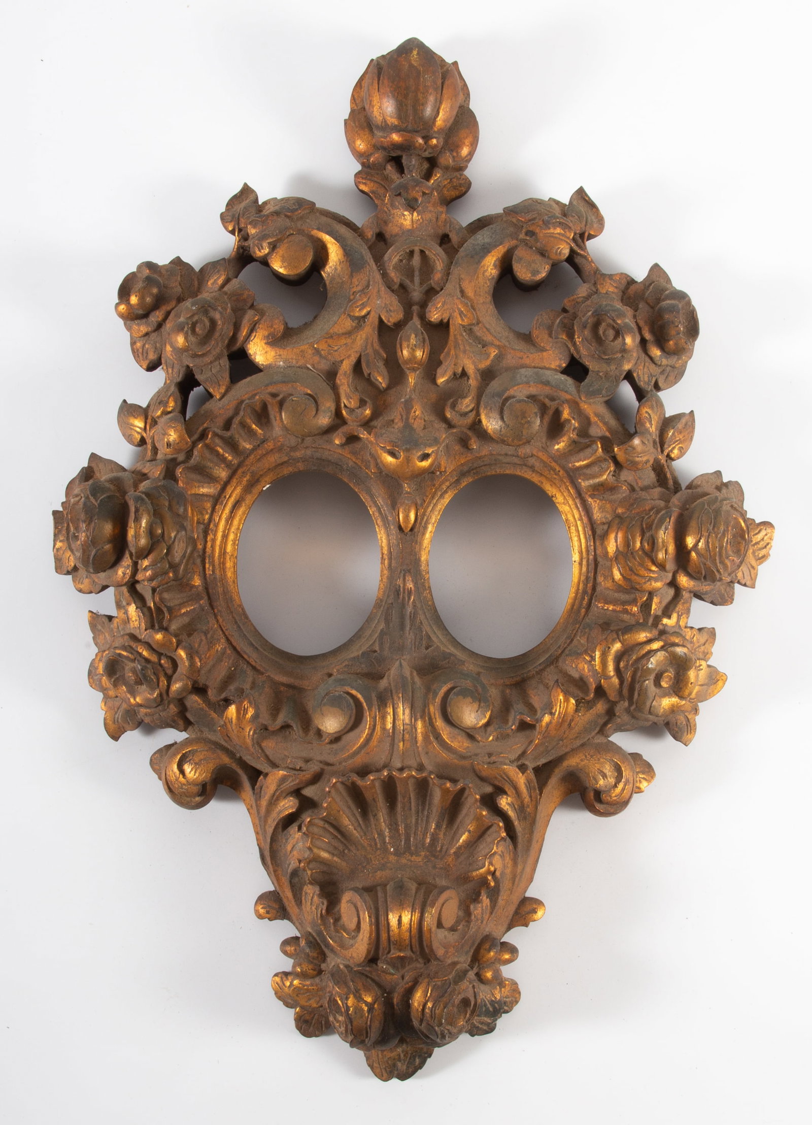 ORNATE ANTIQUE GILT FRAME: Carved wood and gilded; fruit, shell, and floral carved; frame meant for portrait miniatures; H-19"xW-13"; normal wear, G-G+