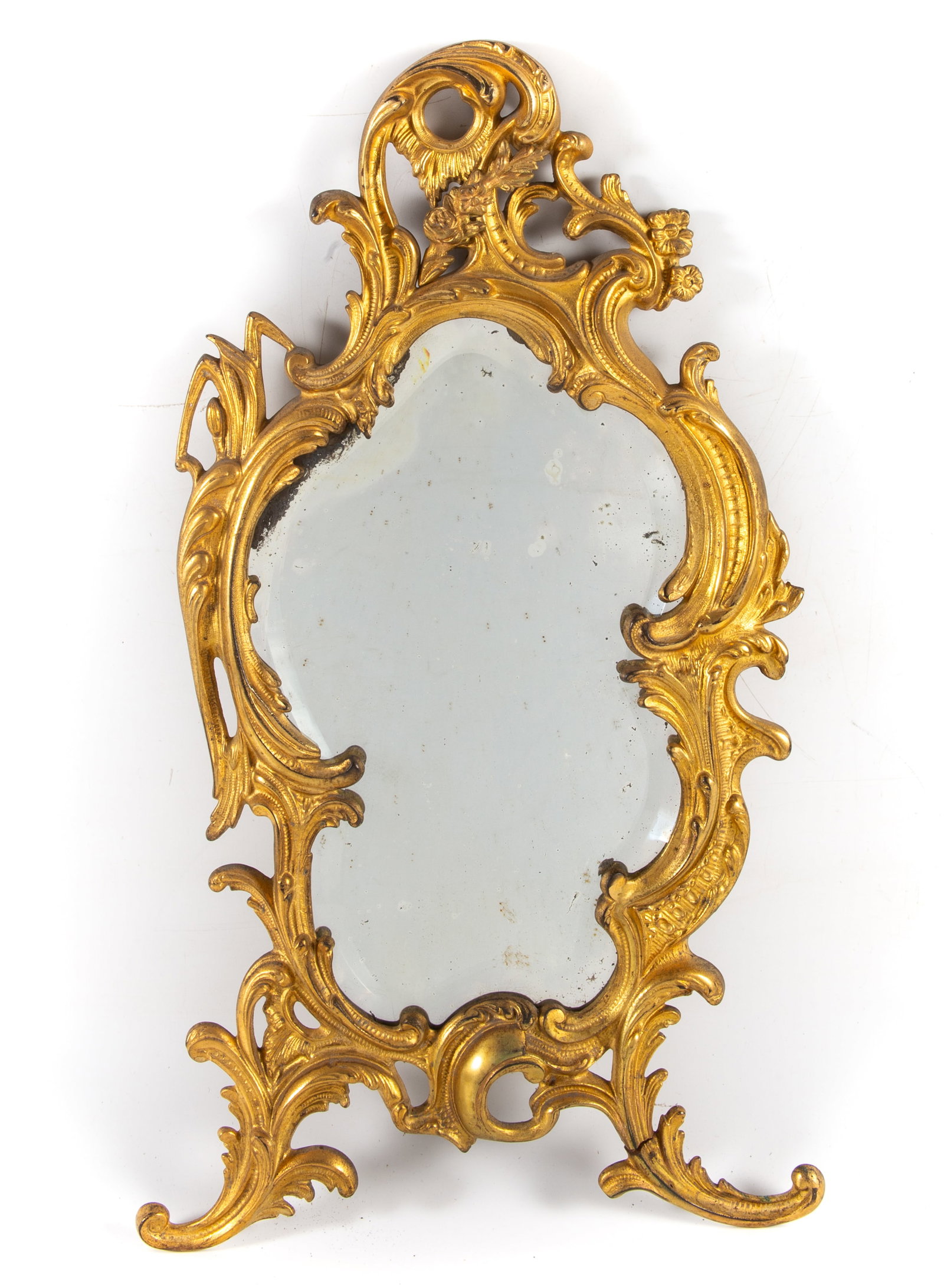 ROCOCO CAST MIRROR: Antique; floral and foliate cast iron with gilding; beveled mirror; H-22 1/2"; (1) foot crack, spots of mirror flaking, F-G
