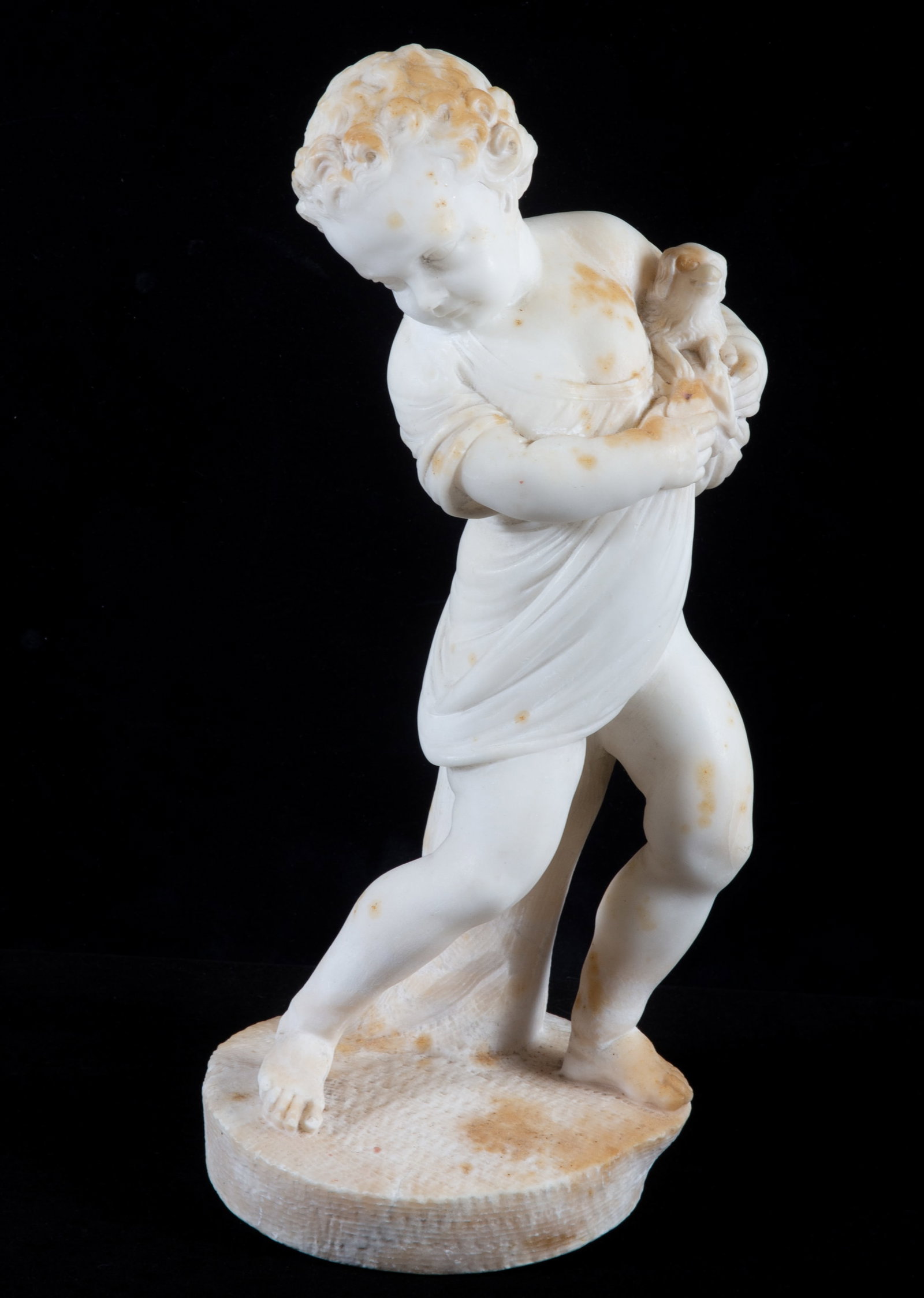 CLASSICAL STONE SCULPTURE: Marble or alabaster; child holding small dog; H-11 1/2"; normal wear, some spots, needs cleaning, G