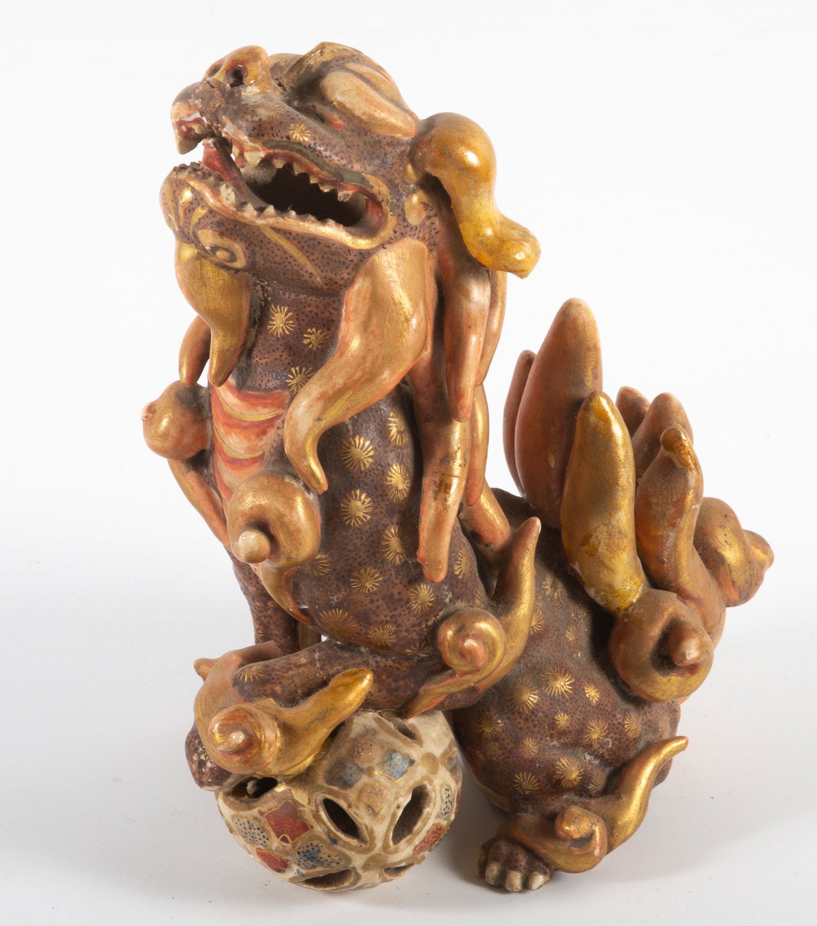 SATSUMA FOO LION: Larg painted ceramic foo lion with paw on openwork ball; H-8 1/2"; wear, some paint loss, F-G