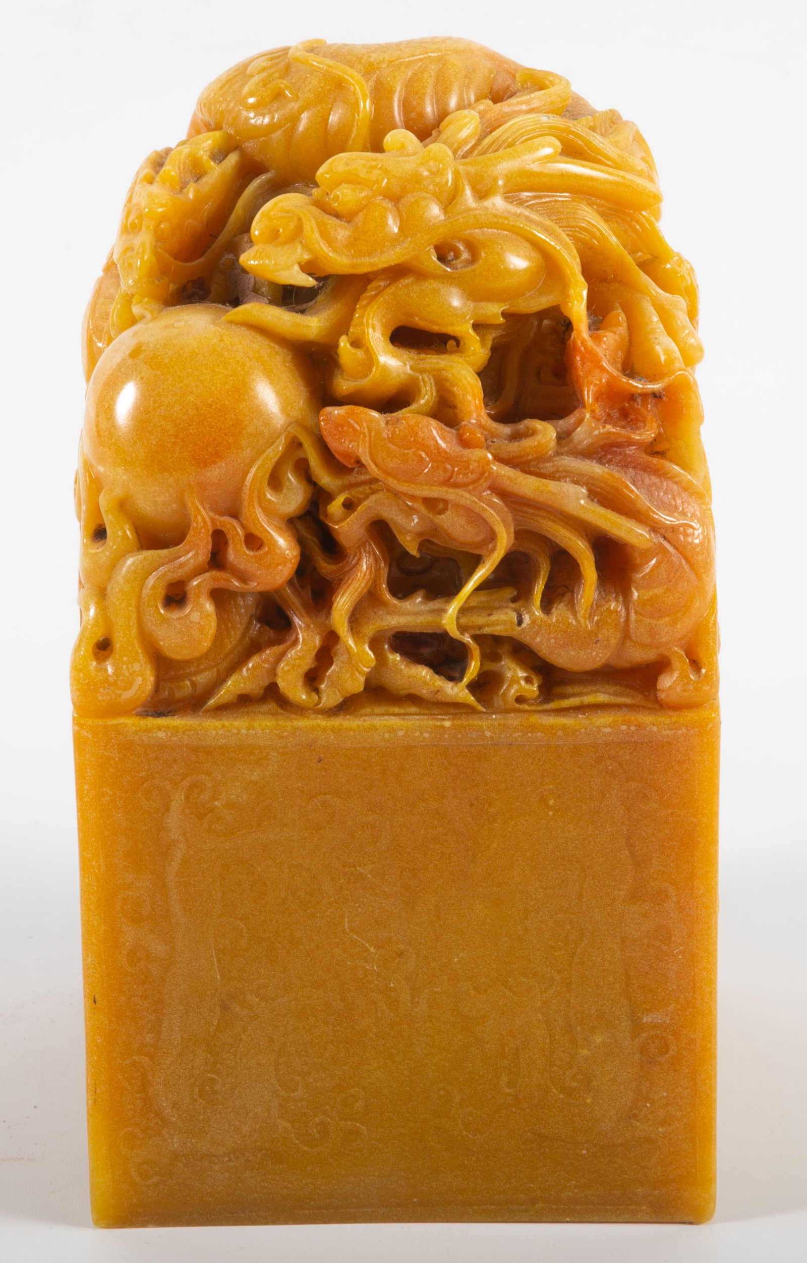 LARGE DECORATIVE CHOP: Carved stone; top intricately carved with dragons, etc.; base is lightly inscribed with dragon motif; H-8"; normal wear, G-G+