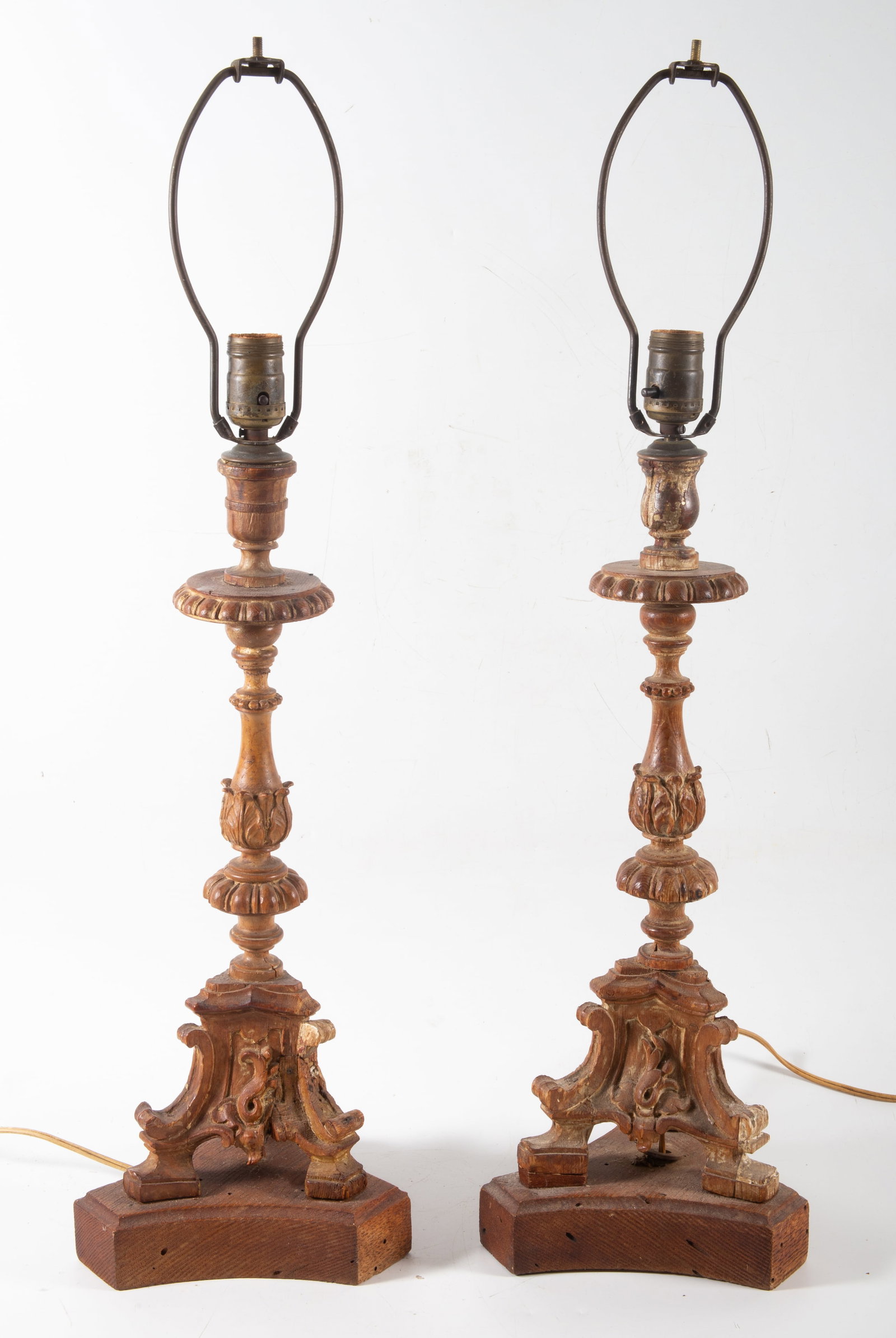 ANTIQUE CANDLESTICK LAMPS: Carved wood; wear, need tightening and rewiring; H-29", F-G