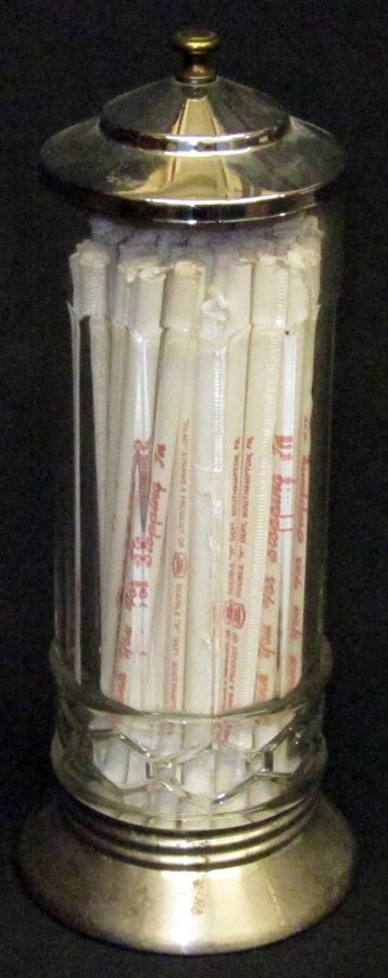 GLASS STRAW HOLDER: Clear glass, arched vertical panels, pressed chain link band at bottom; metal top and bottom; metal bottom band has crack; L-12", G