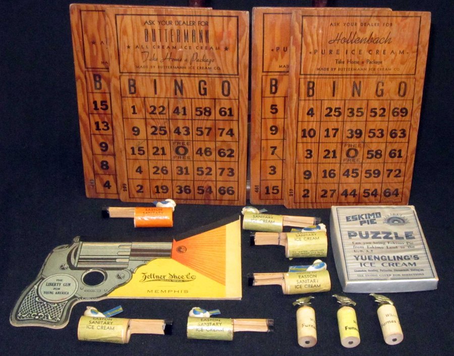 ICE CREAM ADVERTISING PROMOTIONAL GAMES, ETC. (15): (1) Eskimo Pie puzzle - Yuenglings; (4) Bingo boards - Hollenbach & Butterman; (9) bird whistles - Furnas, Easton; (1) Liberty Gun - shoe advertising with Arbuckle pop-out; tallest H-8", G-VG