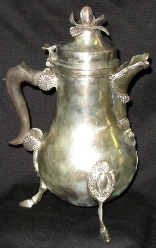 SILVER FOOTED TEAPOT: Foliate finial, applied decoration, cloven hoof feet; touch marks unreadable; 27.24 TO. H-10", G