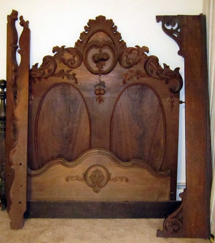 VICTORIAN BED: Walnut, ornate foliate carved crest with flowers and nuts; plain oval panels; needs repair and assembly; H-90", W-56", F-G
