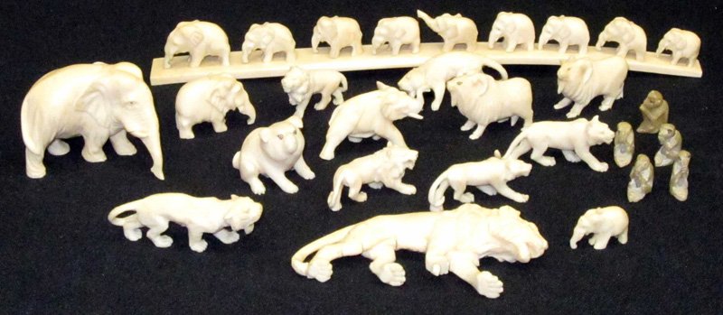 IVORY ANIMAL CARVINGS (15+): Small elephant bridge, lions, elephants, foo dog, etc.; together with small soapstone monkeys; bridge L-8", G-VG