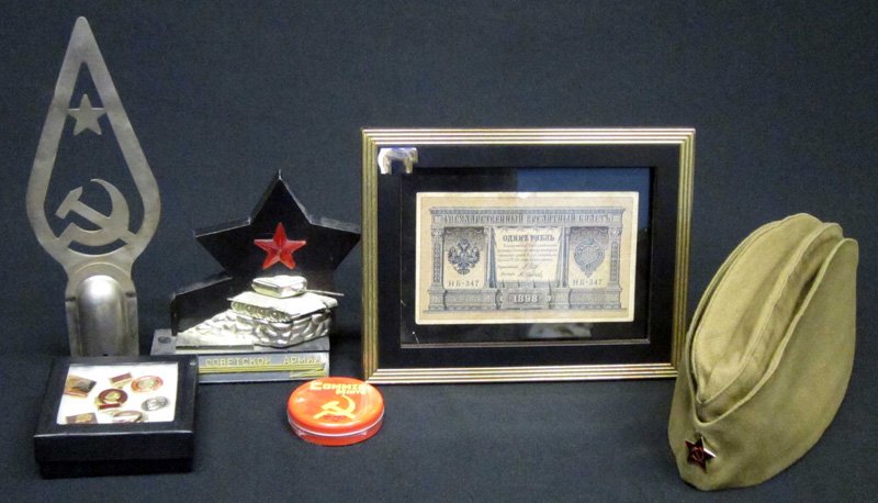 RUSSIAN COLLECTIBLES (6): (1) 1898 currency; (1) enlisted man's cap; (1) flag spike; (1) mints tin; (1) group of enameled pins; (1) tank desk ornament; spike H-9 1/2", G-VG