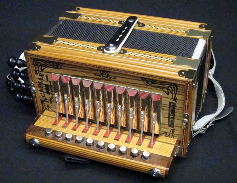 ACADIAN ACCORDION: Plain grain; together with Peavey soft case; H-13", L-13"; EX-NM