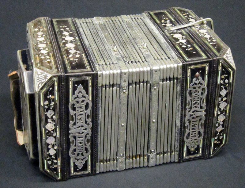 ORCHESTER CONCERTINA ACCORDION: Black lacquered frame with mother of pearl floral and band inlay; corners inlaid with symbols; original hard case; plays, but some bellows splitting; some inlay losses; L-15 1/2", G