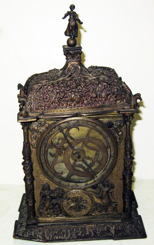 EARLY BASKET TOP SHELF CLOCK: Probably German; mid 19th Century; brass or bronze case with various relief flowers and ornament and (9+/-) function dials; movement not original; dings, dents and possible losses; H-12", F