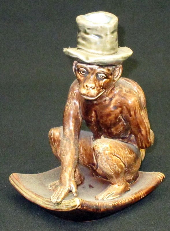 SARREGUEMINES MONKEY CANDLESTICK: Painted ceramic; V1213-227-D1-9; monkey sitting on Darwin book; H-7 1/4", G-VG