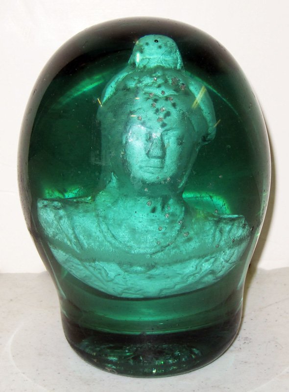 QUEEN VICTORIA DOORSTOP: Large green glass doorstop with sulfide of Queen Victoria inside; some chips, flakes and rubs; H-6", G