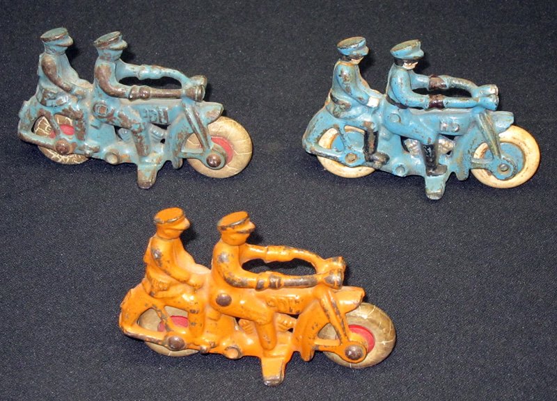 POLICE MOTORCYCLES (3): Painted cast iron; rubber wheels; (1) Harley Davidson, repainted; L-4",F-G
