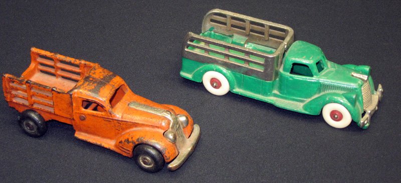 ARCADE & HUBLEY STAKE TRUCKS (2): Painted cast iron and nickel; green Hubley repainted; L-6 1/2", F-G