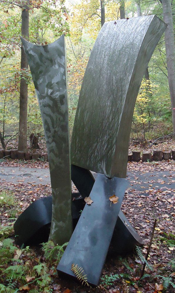 Outdoor Sculpture: Aluminum, vertical members having a brushed / machined surface; aluminum patinated twisted base; Artist: Jon Krawczyk "Shim Sham Cloudy Punch" H-10' 8 1/4"