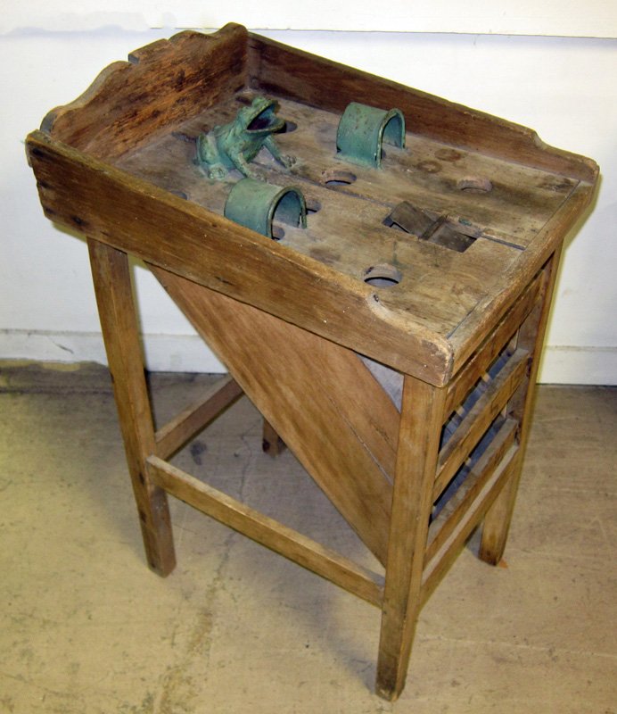 CARNIVAL GAME: Wood with metal frog and hoops and (1) spinning trap; lower numbered slots for points; probably a penny toss; worn and weathered; H-32", L-21", G