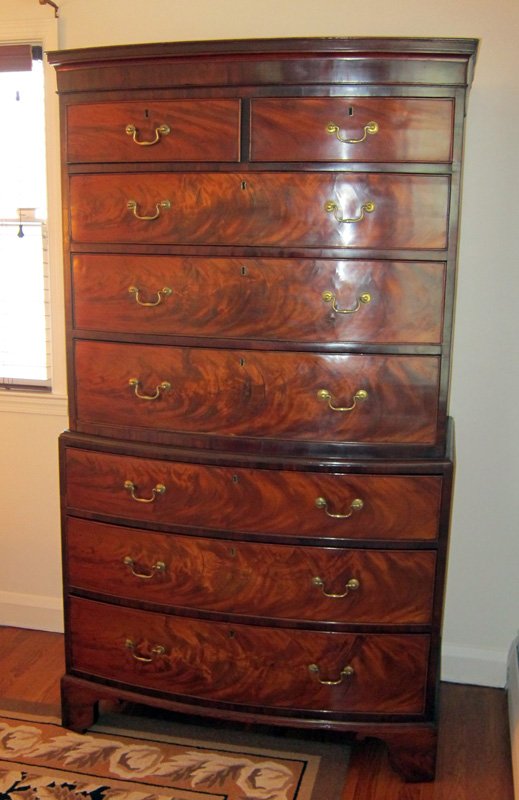 GEORGE III CHEST ON CHEST: Bow front; flame mahogany; original hardware and locks; bracket feet; some minor veneer; checking; H-73", W-42", Depth- 20 3/4". G-VG