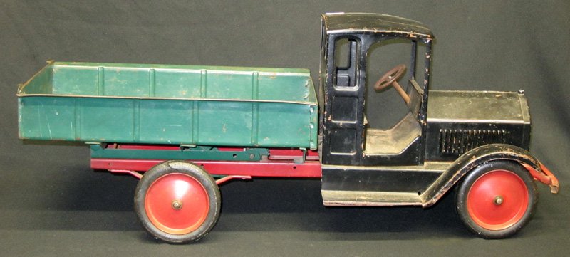 BUDDY L FLAT BED DUMP TRUCK: Painted pressed steel with rubber tires; original paint; some wear and cracks in (2) tires; L-27", G-VG