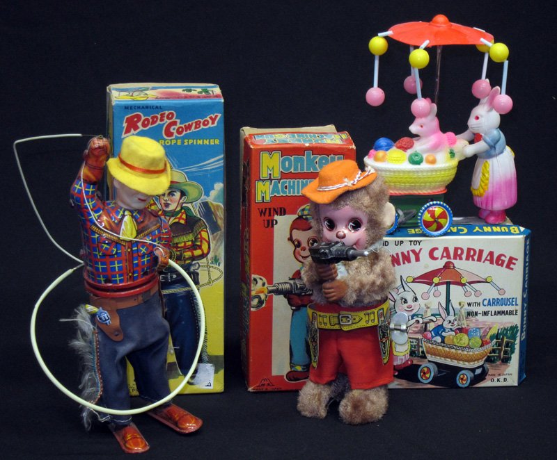 JAPANESE MECHANICAL TOYS (3): Litho tin, plush, celluloid; mechanical wind ups; original boxes; (1) Monkey machine gun; (1) rodeo cowboy rope spinner; (1) bunny carriage; normal wear; tallest H-9", G-VG