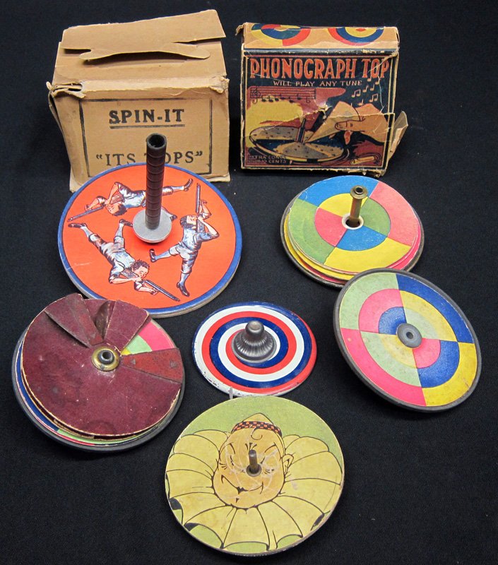 ASSORTED PAPER LITHO TOPS (9+/-): Metal tops with paper litho inserts and box for phonograph top and box for "Spin It" top with original top; Dia.-3 1/2" - 5", F-G