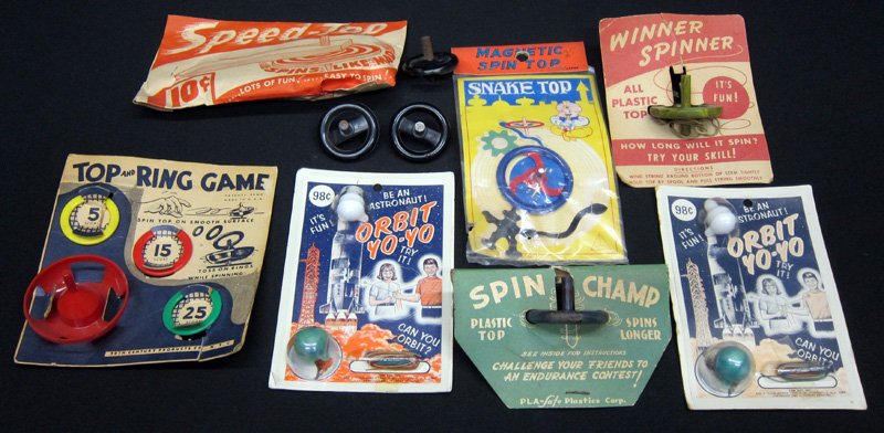 STORE STOCK TOPS, ETC. (10): Plastic and metal; (7) in original packaging; (2) Orbit Yo-Yos; (1) Winner Spinner, (1) Spinchamp, (1) Speed Top, (1) Top Ring Game, (1) Magnetic Spin top; (3) Krazy Tops (not packaged); largest packa