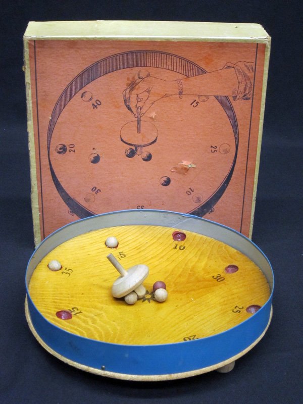EARLY TOP GAME: Wood and metal; spin top that knocks balls into points holes; original box; 10" x 10", VG