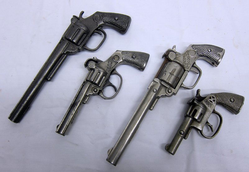 COWBOY CAP SHOOTERS (4): Nickeled cast iron; Bob, Sliko, etc.; (1) "Lasso 'em Bill" broken; longest L-9", P-G