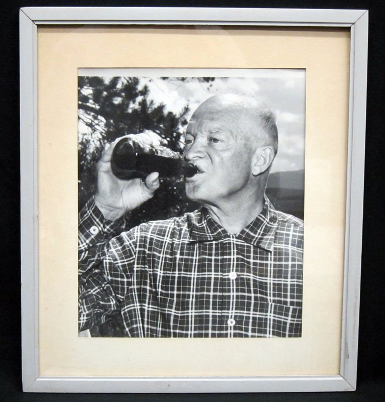 EISENHOWER DRINKING COKE: Photograph of Ike drinking a bottle of Coca-Cola; matted and framed; image: 12" x 10", VG-EX