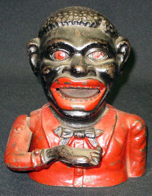 JOLLY N MECHANICAL BANK: Painted cast iron; some old overpaint and varnished eyes overpainted; replaced base plate; H-6 1/2", P-F