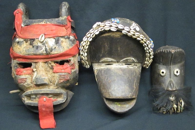DAN COMPLEX MASKS (3): Liberia or Ivory Coast, (1) carved wood, cloth, shells, hair and fur; (1) carved wood with beads, cowrie shells; (1) carved wood, metal, feathers and hair; normal wear, filler, bug damage and chips; H