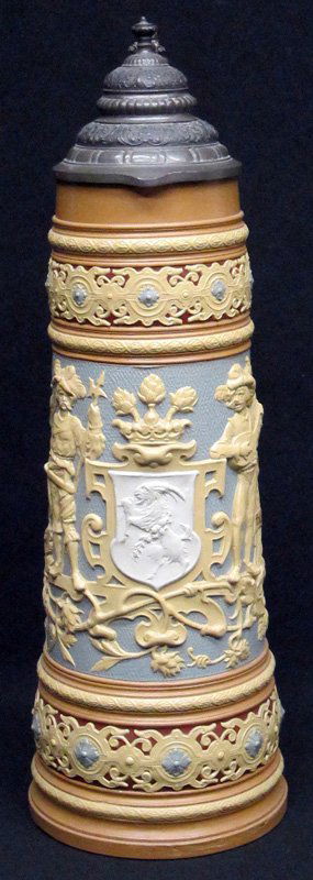 METTLACH PITCHER: Ceramic with relief decoration; pewter top; #1739; possible lower edge repair or mold flaw; H-18 1/2", G-VG