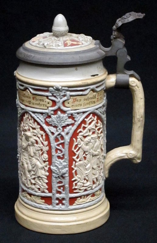 METTLACH STEIN 1/2 L: Painted ceramic with relief decoration; pewter and ceramic top; #24; some wear and minor interior stains; H-8 1/2", G