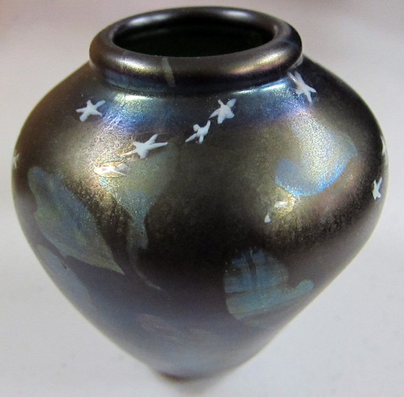 LOUIS COMFORT TIFFANY CABINET VASE: Signed "LCT 2177E", base glass is dark green (appearing black); decorated with white stars and silver blue leaves; H-3 1/4", W-3" at shoulder, EX