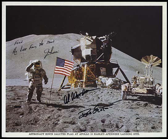 1971 CREW SIGNED LUNAR SURFACE LITHO: An original NASA 8"x11" color litho showing Astronaut Jim Irwin saluting the flag on the lunar surface. Signed in black marker by Apollo 15 Astronauts Jim Irwin, David Scott and Al Worden. Inscribed b
