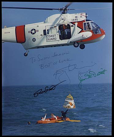 1969 COMPLETE CREW SIGNED TRAINING PHOTO APOLLO 9: Color photo (8x10") that shows the Apollo 9 astronauts during recovery training. Photo signed in green sharpie by Jim McDivitt, black sharpie by David Scott and blue ball point pen by Russell Schweick